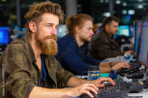 Focused it professionals collaborating at a modern office urban environment workstation teamwork concept