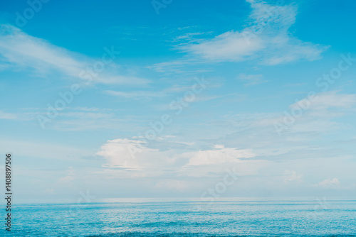 Fototapeta Naklejka Na Ścianę i Meble -  Open sea and blue sky with soft waves ideal tropical beach background for vacation themes.
