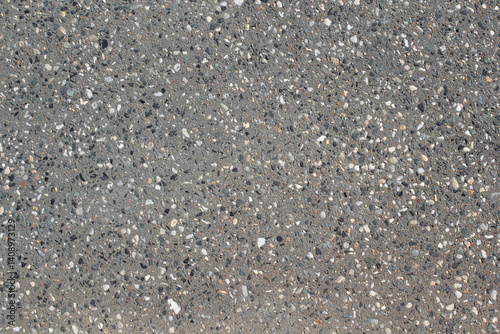 Light grey gray concrete surface with exposed aggregate stones textured background