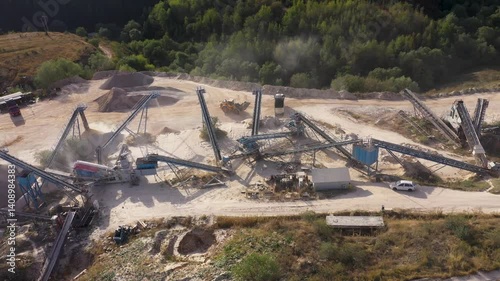 Aerial view of stone quarry conveyor belt system in operation, stone jaw crusher plant