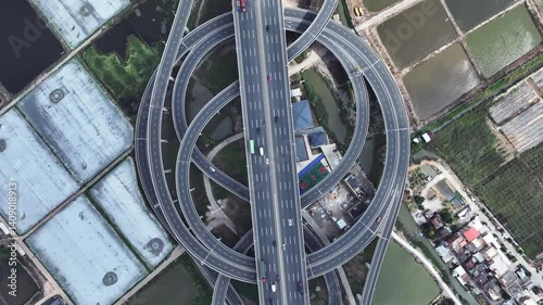Multi-level overpass China. Lot cars drive on transportation interchange. Road traffic. Chinese economy. Aerial top drone above view of fast urban highway. Modern city freeway. Busy auto express way.