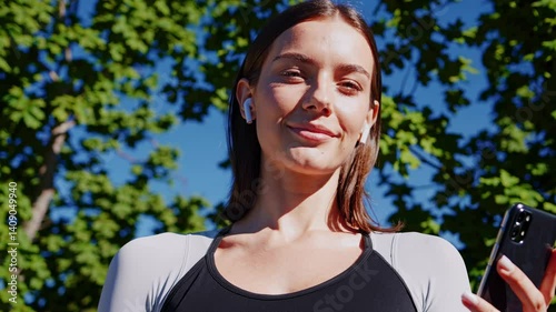 The Woman with Smartphone Earbuds