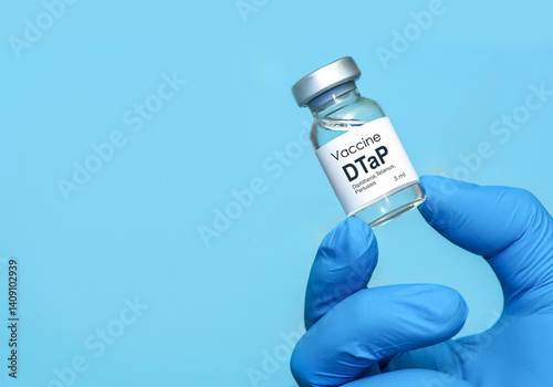 Obraz na płótnie Doctor or nurse hand in medical gloves holds vaccine for DTaP diphtheria, tetanus and Pertussis. Concept of healthcare, immunization, medical protection, and scientific research in medicine.Copy space w salonie