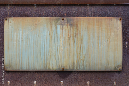 Obraz na płótnie A heavily weathered metal panel displays rust and discoloration in a rustic environment, showcasing signs of age and exposure to the elements through time w salonie