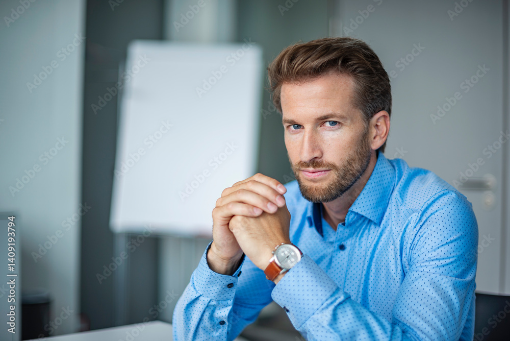 Serious businessman in a modern office looking at the camera