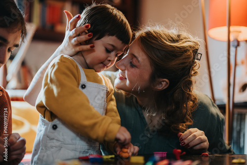 Billede på lærred A touching moment of a mother lovingly holding her young child in a comforting embrace, depicting strong familial bonds and affection, in a cozy home environment filled with warmth