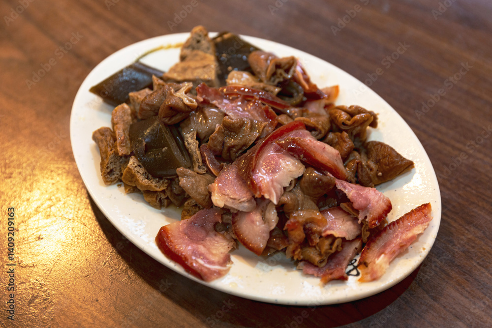 Close-up of Taiwanese braised dish with pork, tofu, and intestines, highlighting traditional cooking techniques and bold, rich flavors Close-up of Taiwanese braised dish with pork, tofu, and intestines, highlighting traditional cooking techniques and bold, rich flavors