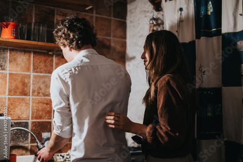 Canvas Print A couple shares a bonding moment in a cozy kitchen, reflecting warmth and intimacy