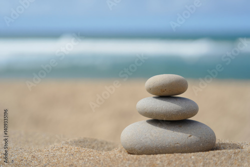 Tranquil beach scene with stacked stones on sandy shore