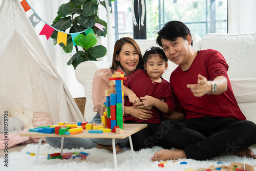 Cherry young mother plays colorful toy block with her Down syndrome daughter,  colorful wooden toys can increase skills and learning to increase the development, special education, Knowing slowly