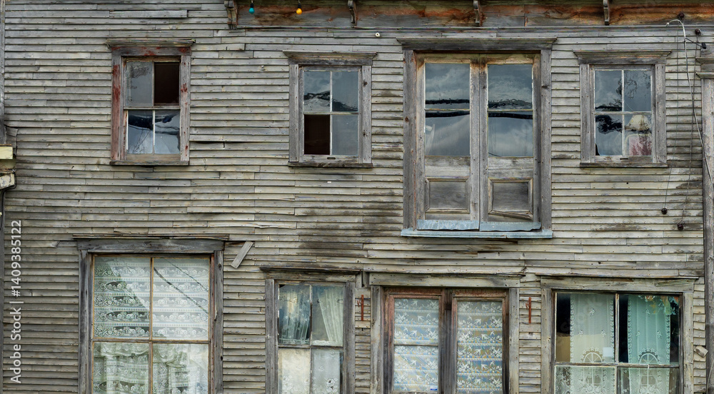Naklejka premium old wooden house with different windows
