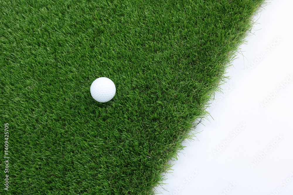 Golf ball and green grass on white background, top view. Space for text