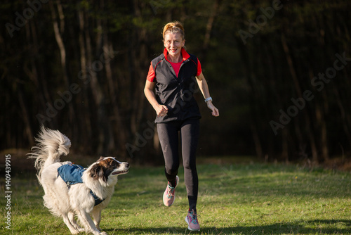 Obraz na płótnie fit happy woman running with her dog outdoors w salonie
