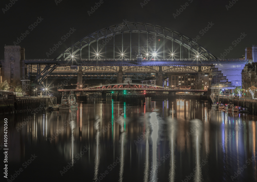 Stunning night view of the Newcastle upon tyne with Tyne bridge, Swing bridge and The High level bridge spanning the River Tyne connecting Newcastle upon tyne and Gateshead in North East England.