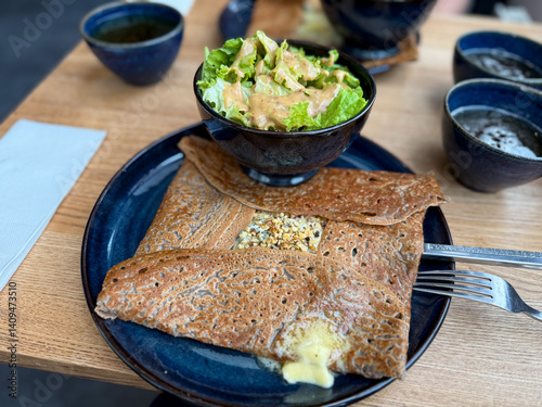 Fotografie Traditional Crepe Galette made from buckwheat flour with cheese and nuts on a pl