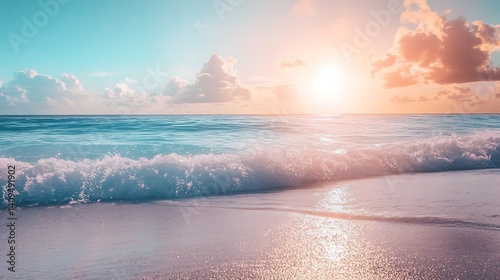 Obraz na płótnie Sunset over the ocean with waves splashing on a sandy beach under a blue and pink sky w salonie