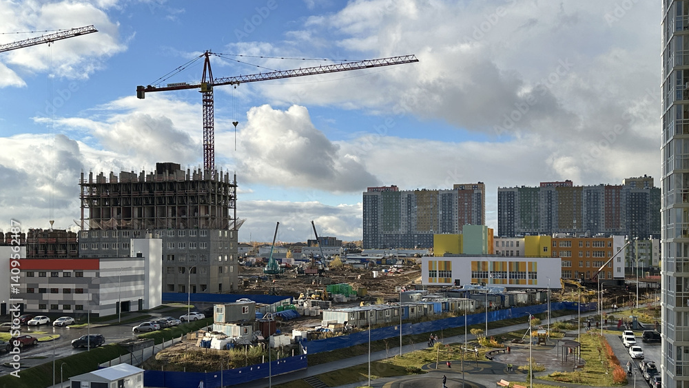 Construction of new multi-storey residential buildings outside the city in Russia. Tower crane operation. Housing construction concept
Construction of new multi-storey residential buildings outside the city in Russia. Tower crane operation. Housing construction concept