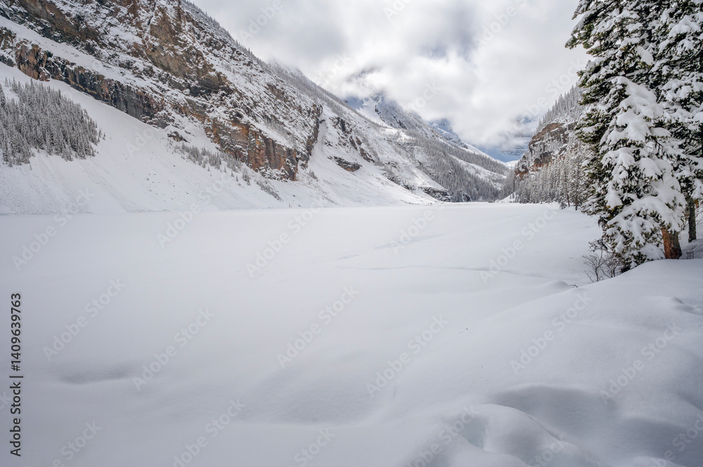Clouds over snow covered Lake Louise in Banff National Park, Alberta, Canada
