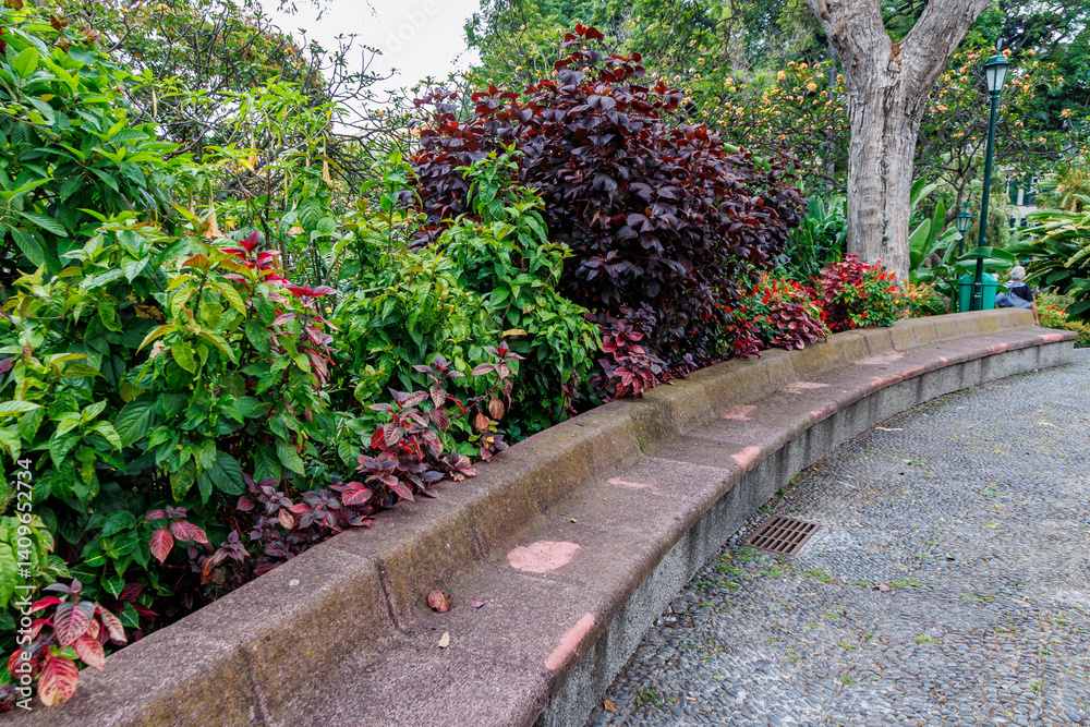 Stone benches in Municipal Garden in Funchal city, capital of Madeira Island, Portugal