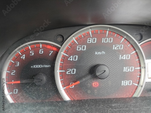 Close-up of a car's dashboard showing the speedometer and tachometer. Interior vehicle details