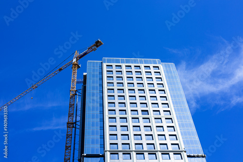 Wallpaper Mural Construction crane near high-rise building against sky background Torontodigital.ca
