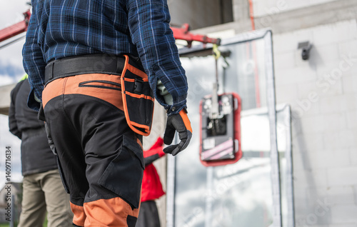 Workers Handle Equipment During Construction Project in Urban Area