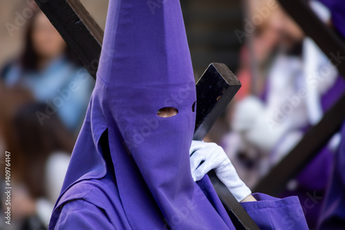 Nazareno with the cross and the hood in the Good Friday procession of Holy Week in Murcia, Spain dressed in blue