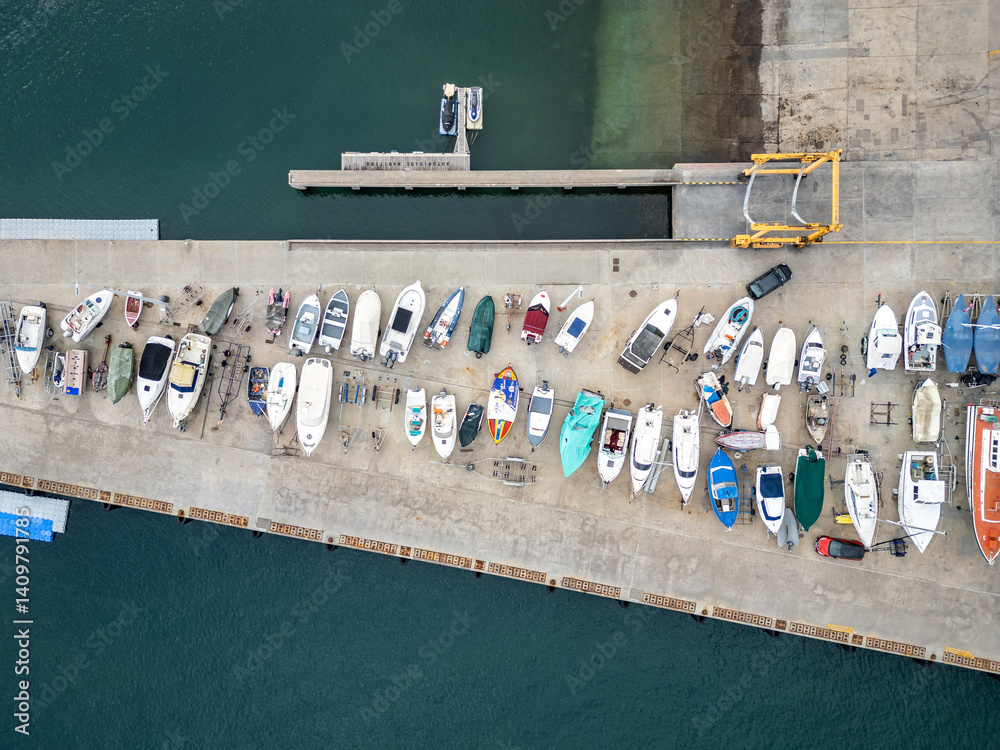 Boats on a quay of marina in Funchal city, capital of Madeira Island, Portugal