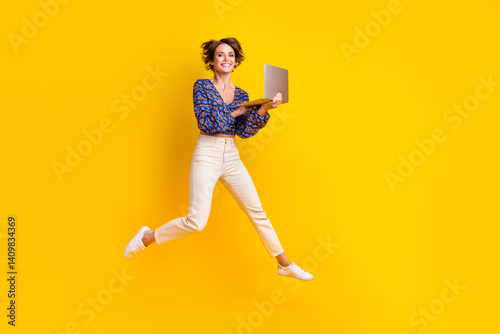 Obraz na płótnie Full body length photo of happy apple macbook pro enjoyer girl loves her new computer jumping air isolated on yellow color background w salonie