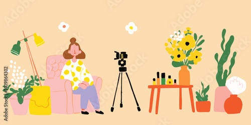 A vibrant scene unfolds as a young woman, enveloped in a cozy atmosphere, creates content in her home studio, a camera captures every moment of her creative process.