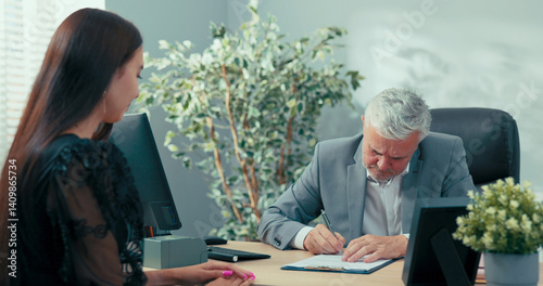 Candidate for the position of secretary to the boss in the company is at a job interview, a young girl signs a contract for an indefinite period, gives the manager the document to sign