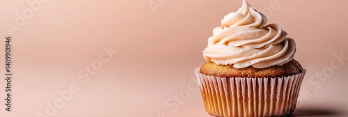 A cupcake with a generous helping of frosting is set against a spotless background