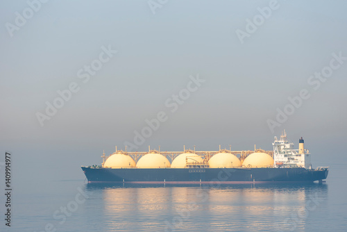 Photography LNG tanker ship, with visible specific ball shaped tanks, anchored near entrance to the port of Jebel Ali, large gas trade terminal near Dubai