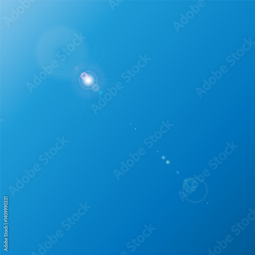 The sun, located at the top of a clear blue sky, emits a bright light, creating a lens flare effect with soft rays directed downwards.