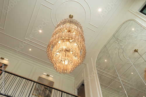An elaborate, crystal chandelier in a hotel lobby or luxury home.