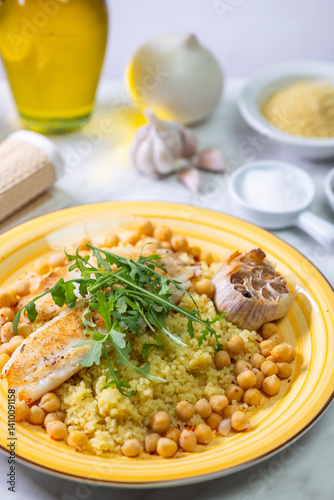 Obraz na płótnie grilled cod with couscous, chicken pea and baked garlic w salonie