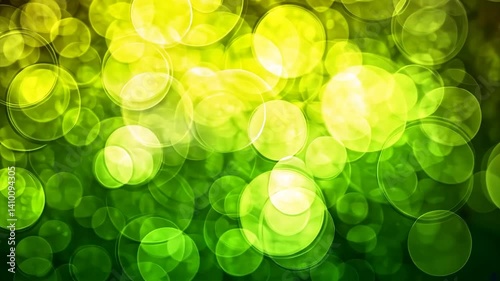 Abstract green and yellow bokeh background with bright circles.