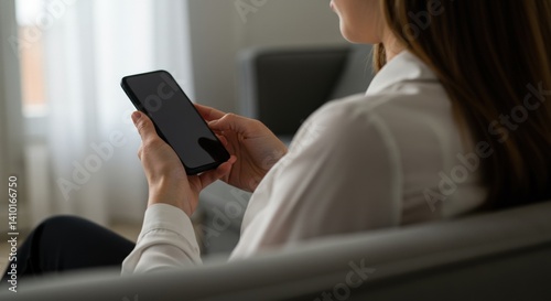 Close up photo businesswoman using phone with white while lying on couch