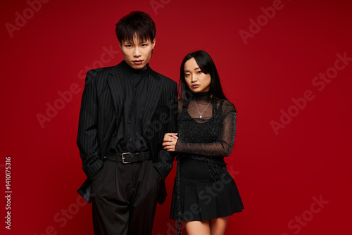 Fotografie Stylish couple embodies love and romance against a vibrant red backdrop of passi