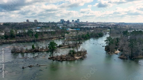 Aerial push-in footage over the Congaree River with the Columbia, SC skyline in the background.