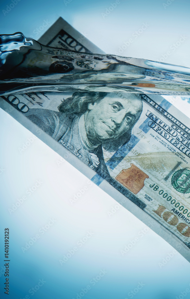Global economic and financial crisis. Close up US Dollar bills sinking in water as symbol of uncertain future of international trade and investment. Copy space.