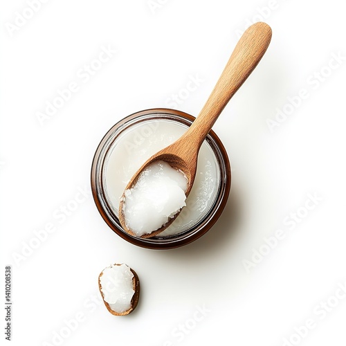 Top view of coconut oil in jar with wooden spoon for beauty and cooking on white background isolated