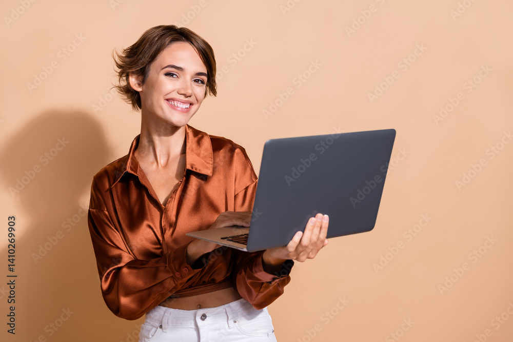 Photo of adorable pretty girl wear brown blouse chatting instagram twitter telegram facebook empty space isolated beige color background