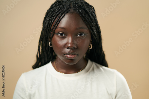 Young black woman posing with braided hair and white t-shirt