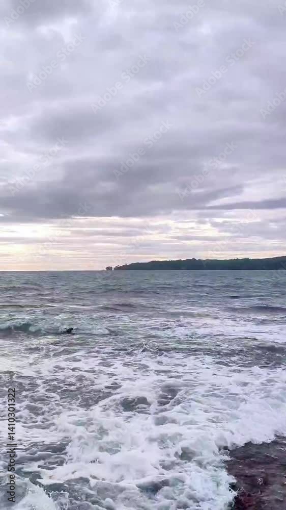 Rocky Seashore with Calm Water and Cloudy Sky a Scenic Natural Beauty Rocky Seashore with Calm Water and Cloudy Sky a Scenic Natural Beauty