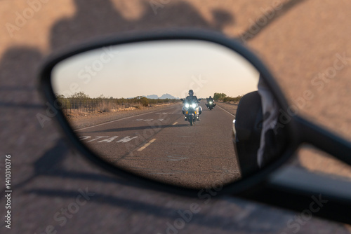 Watch for cattle painted on desert road with motorcyclists rear view mirror reflection lonely isolated desolate cows highway biker motorbike motorcycle
