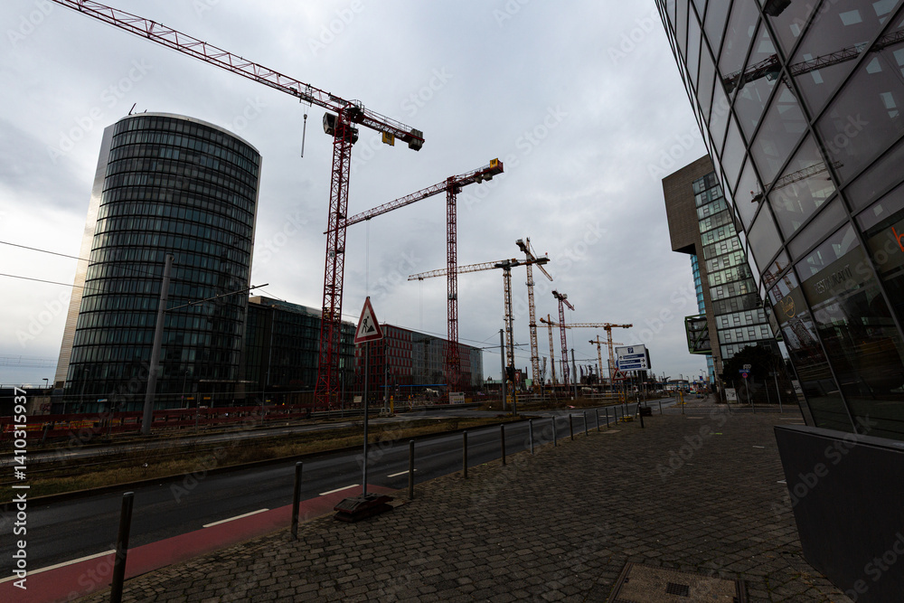 Cranes on construction site and foggy sky
