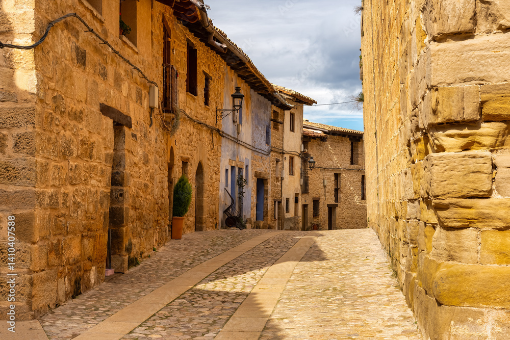 Picturesque alley with colourful stone houses in the medieval village of Valderrobres, Teruel.