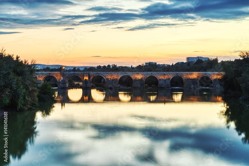 Illuminated Mezquita Cathedral and Roman Bridge in Cordoba at Sunset, Andalusia