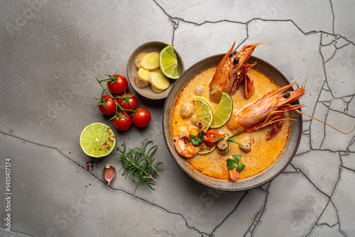 Obraz na płótnie Tom Yam kung Spicy Thai soup with shrimp, seafood, coconut milk and chili pepper in a bowl, top view with copy space w salonie